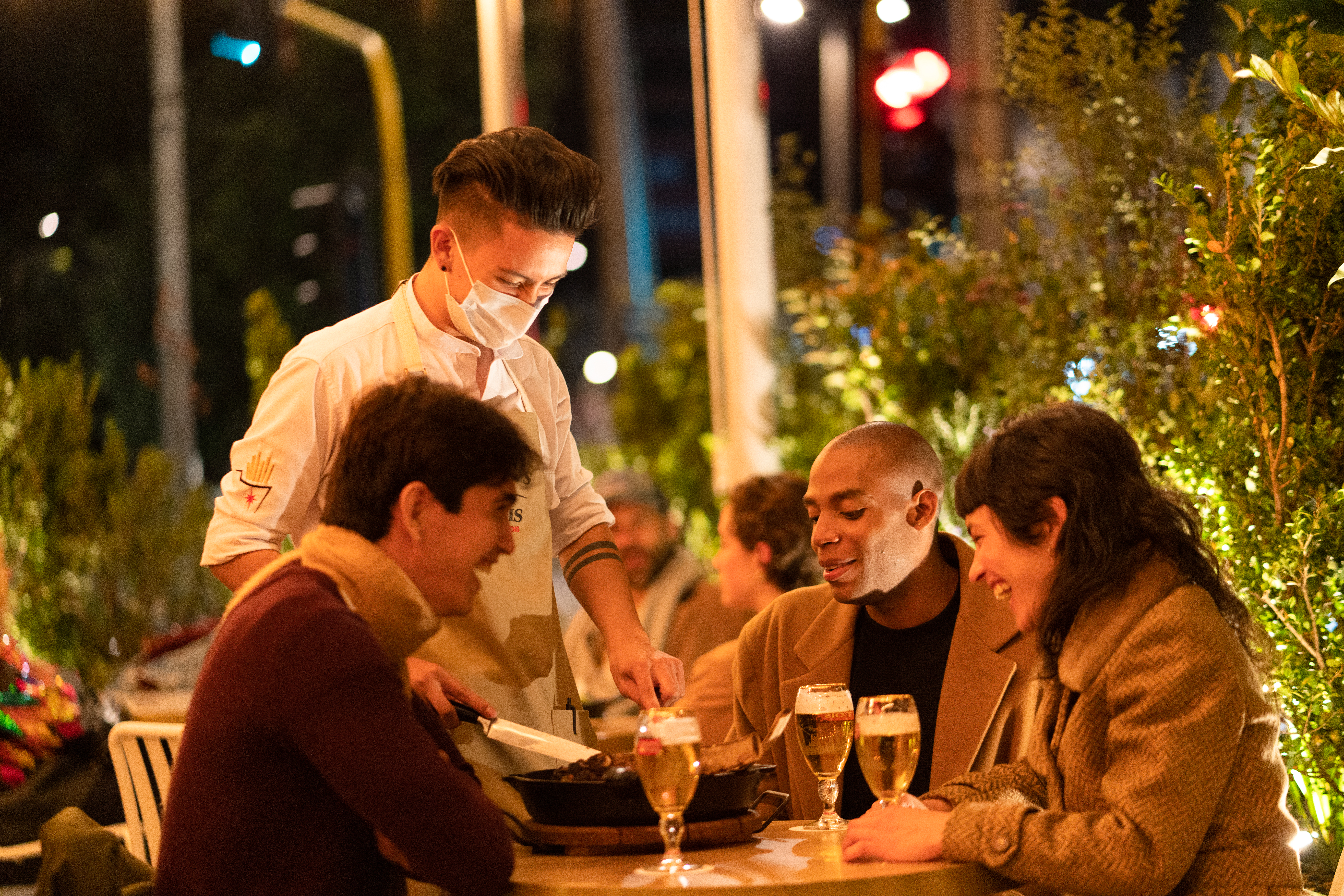 Image of Waiter and friends having dinner