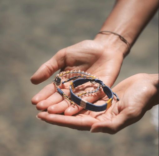 Photo of a bracelet in a person's hand.
